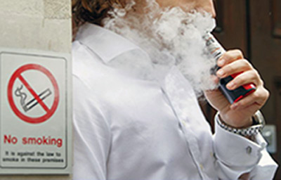 E-liquid bottles and a vape device on a shelf